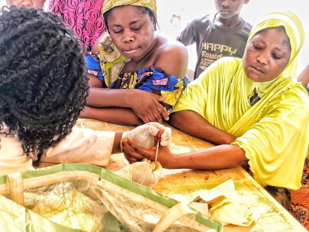 GLF volunteer conducting free medical tests at an outreach